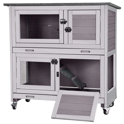 Gray two-layer wooden rabbit hutch with waterproof roof, metal wheels, and multiple access doors for indoor and outdoor use